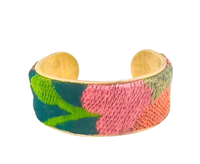 The 1-inch France cuff bracelet features vibrant pink, red, and green embroidered floral designs on a vintage brass base. A bold yet elegant accessory handcrafted by Redd Dott Jewelry.
