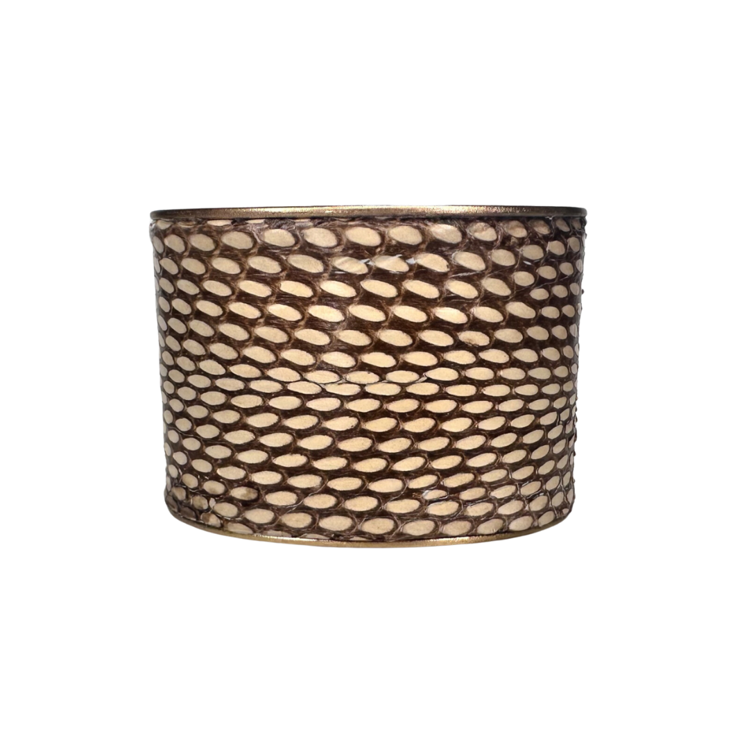 A 2-Inch Redd Dott Jewelry cuff made with a gold brass cuff bracelet featuring genuine preserved Eastern Brown snake skin with natural geometric scale pattern and warm bronze hues; one of a kind jewelry.