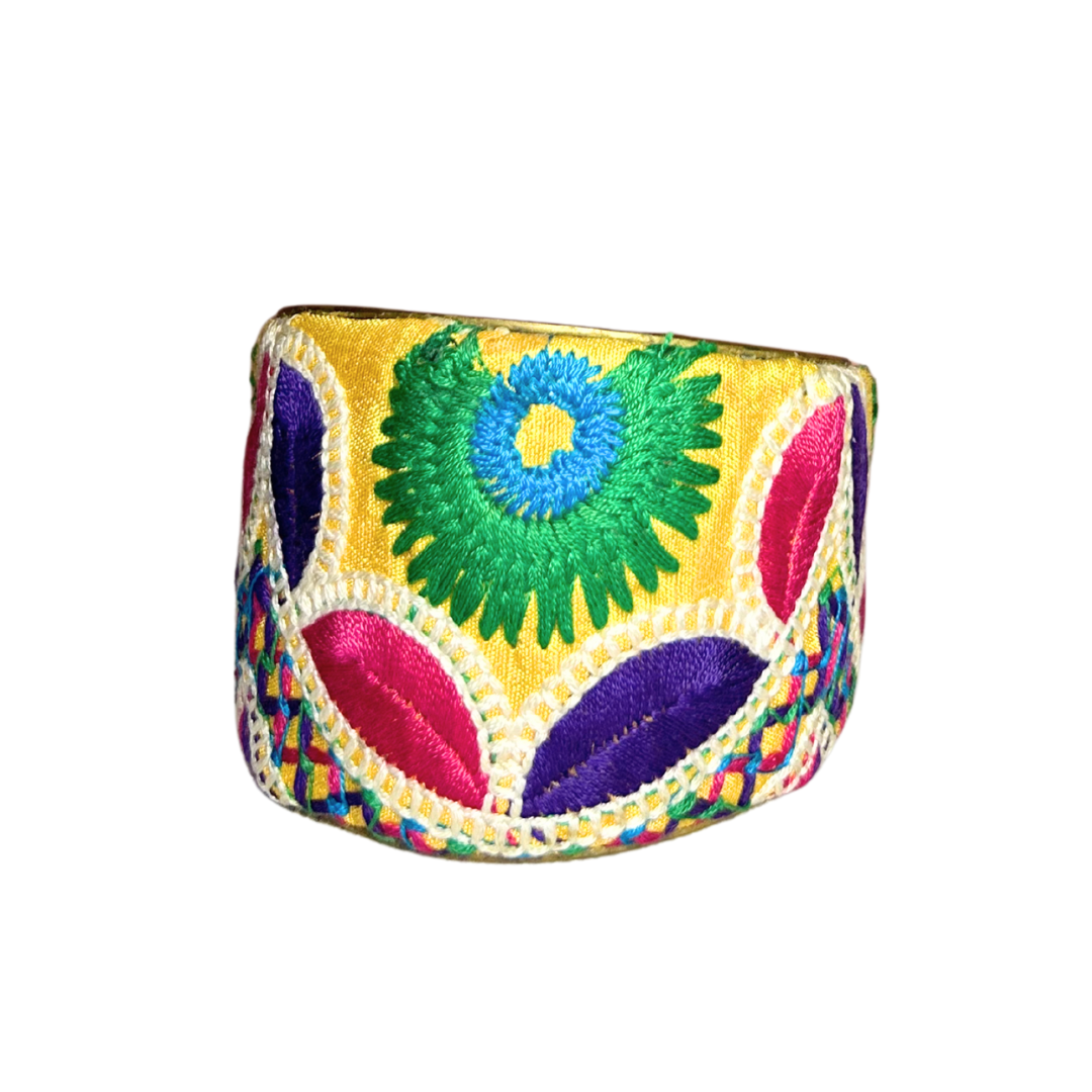 The Ababa cuff bracelet, handcrafted from a vintage brass bracelet base, features a bold, colorful embroidered overlay. This adjustable brass cuff bracelet blends expressive artistry with timeless charm.