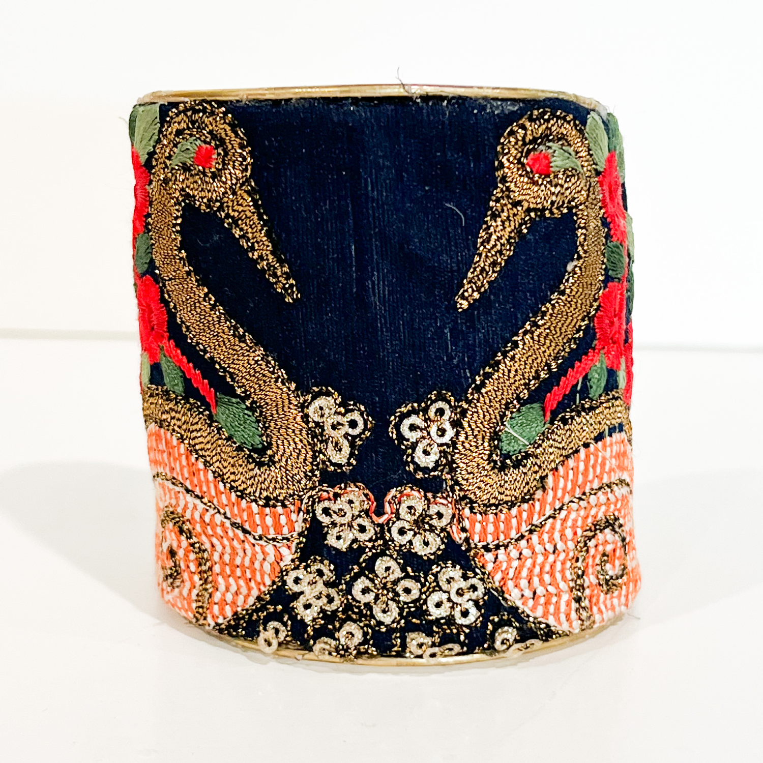 Front view of Annalee Brass Cuff Bracelet with twin gold embroidered swans on navy fabric and coral detailing, handcrafted in Shreveport, LA by Redd Dott Jewelry.