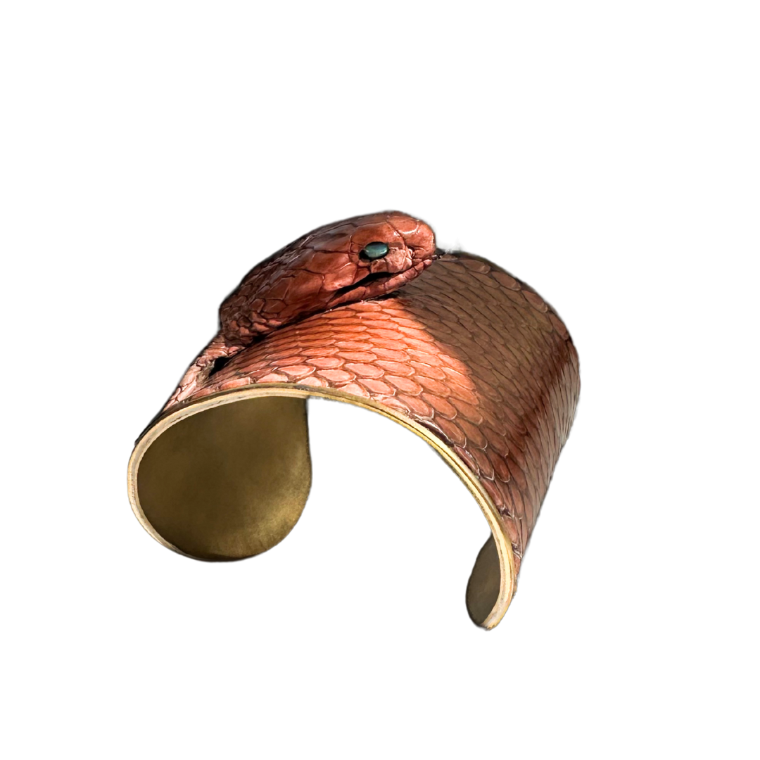 3-inch wide brass cuff bracelet wrapped in genuine copper-toned cobra snakeskin with the serpents head and opal eyes; handcrafted one-of-a-kind jewelry by Redd Dott.