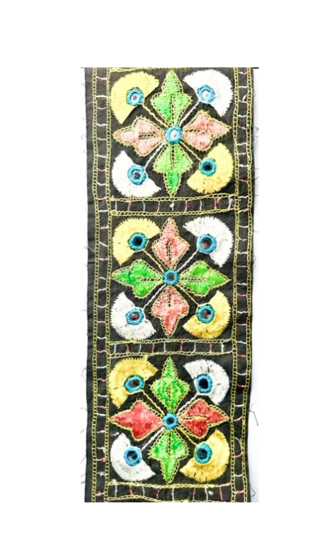 Indian-inspired embroidered cuff bracelet showcasing a detailed floral pattern in vibrant colors of green, pink, yellow, and blue on a black background, highlighting intricate craftsmanship in traditional jewelry design.