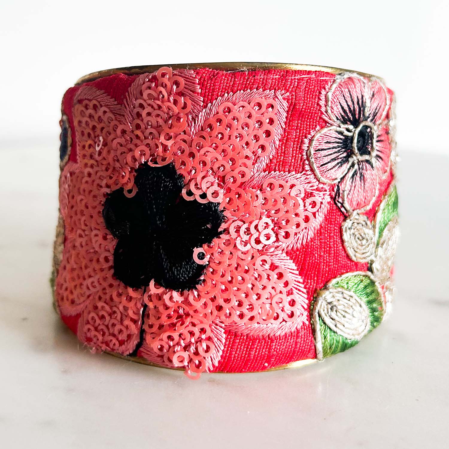 Avalon floral cuff bracelet – red vintage fabric with pink sequin flowers and navy embroidered blooms on a handcrafted gold-edged brass cuff.