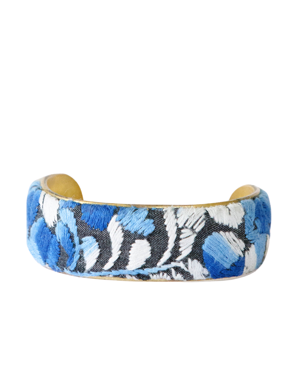 Close-up of 1-inch Azul Profundo brass cuff bracelet with deep blue and ivory Mexican embroidery from the Margarita Mercantile × Redd Dott collection.