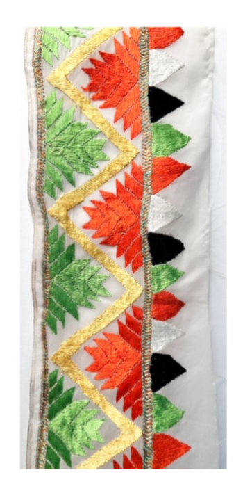 Geometric cuff bracelet featuring a vibrant pattern in green, yellow, orange, and black with gold accents, showcasing a bold and modern design.