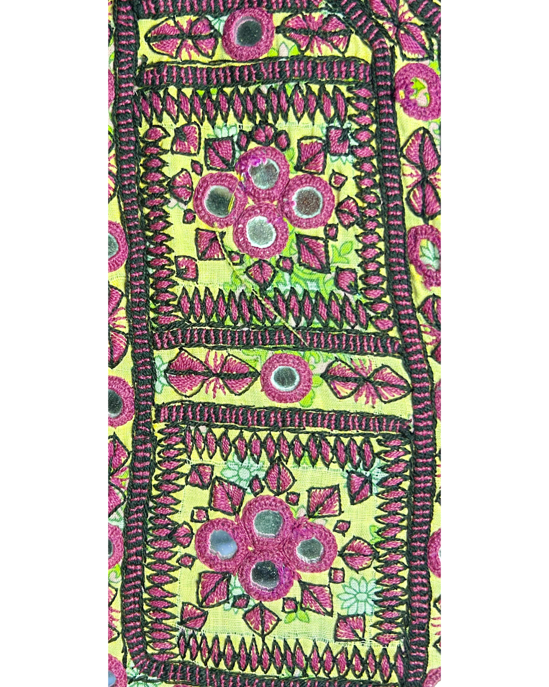 A handcrafted custom stamped cuff bracelet by Redd Dott Jewelry featuring vibrant magenta floral embroidery, mirrored accents, and bold black stitching on bright chartreuse fabric. A striking piece of embroidered jewelry.