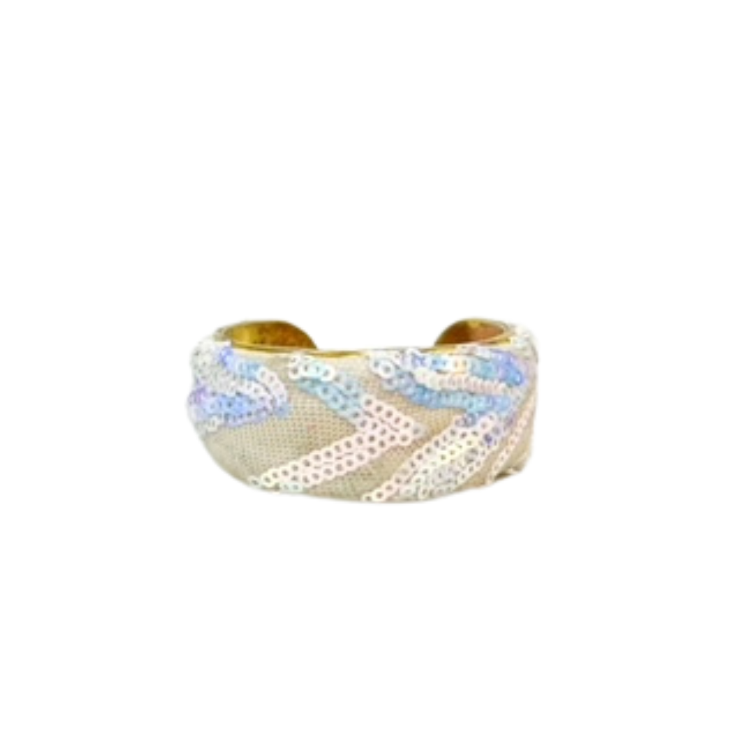 A 1-inch wide brass cuff bracelet featuring ivory mesh overlaid with soft pastel sequins in undulating wave patterns. This refined brass cuff bracelet stands out as one of a kind jewelry and a favorite among cuff bracelets for women.