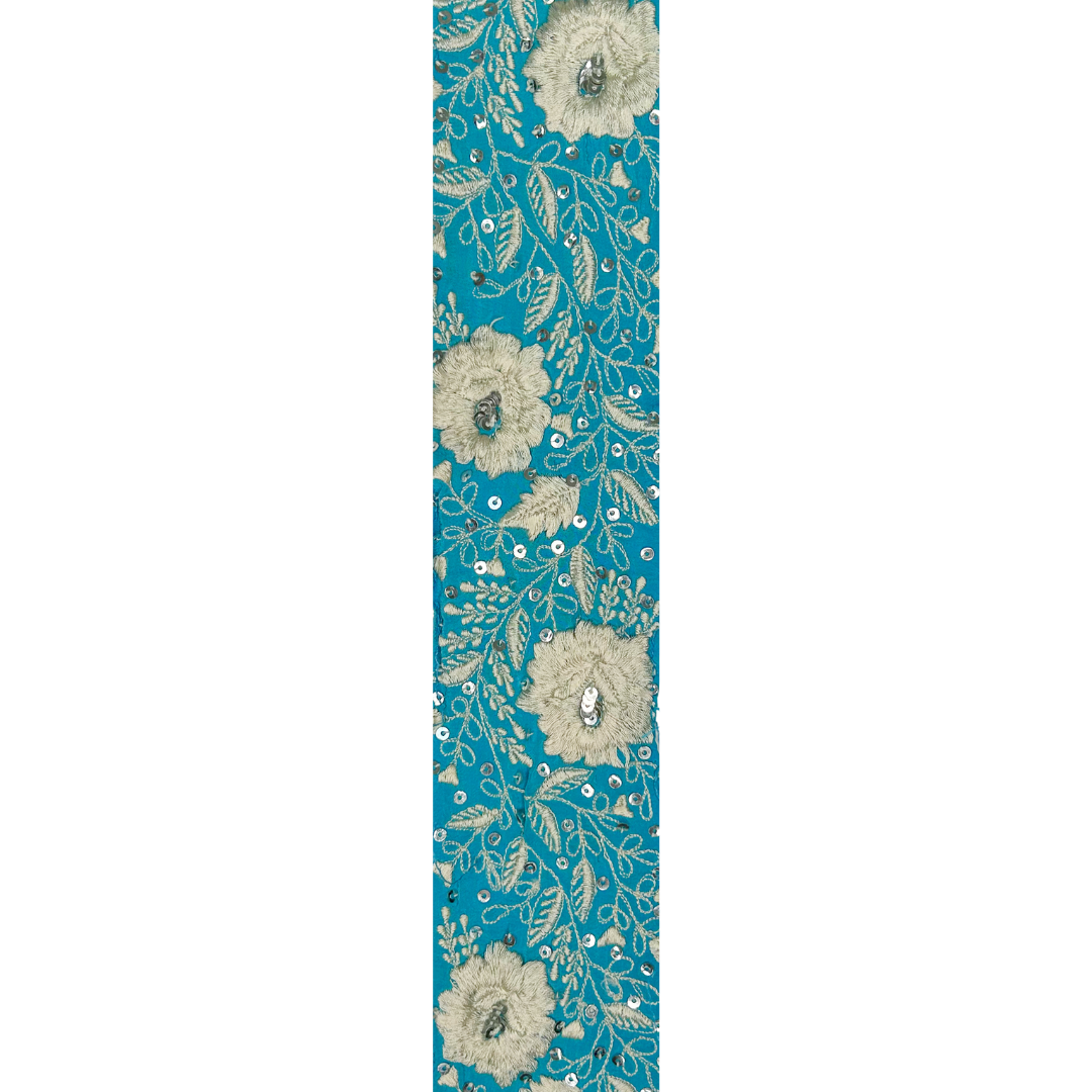 Casper fabric detail – embroidered ivory flowers and vines on teal with sequin accents, perfect for handmade floral cuff bracelets.