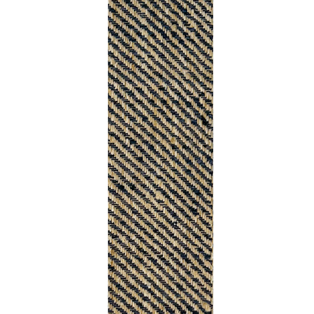 A rustic cuff bracelet by Redd Dott Jewelry, featuring a diagonal woven pattern in deep black and warm beige.
