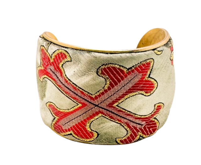 Handmade brass cuff bracelet from Redd Dott Jewelry featuring a red cross embroidered on golden fabric, crafted in Shreveport, LA, with an optional personalized interior message.