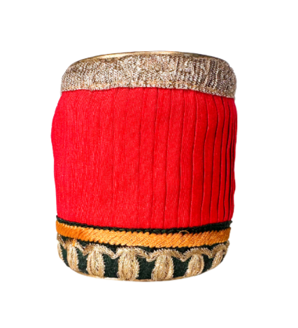 Dior red and gold cuff bracelet featuring a bold red fabric with intricate gold embroidery and trim, offering a luxurious and eye-catching design.