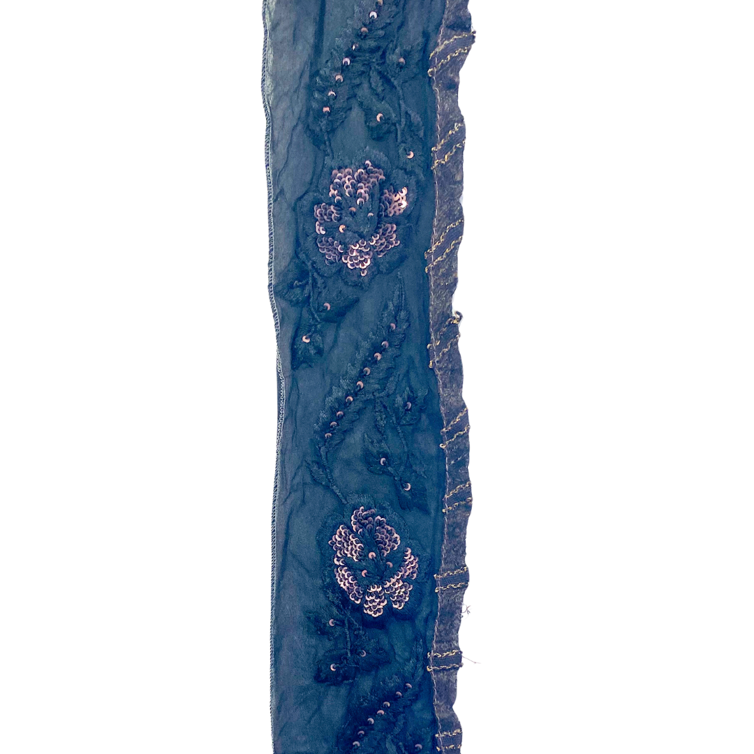 Handcrafted sequin bracelet by Redd Dott Jewelry, featuring a black fabric base with intricate floral embroidery, shimmering sequins, and a hand-stamped personalized message inside.