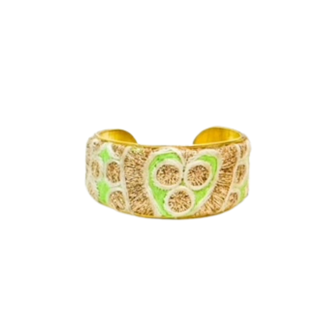 The Everlee cuff bracelet in its 1-inch variation, showcasing metallic gold embroidery and green heart patterns on a brass base