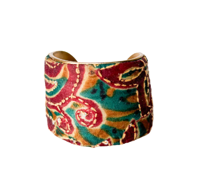 Orange and turquoise paisley pattern cuff bracelet featuring intricate, colorful designs with vibrant swirls and floral motifs on a brass base, offering a bold and artistic accessory.