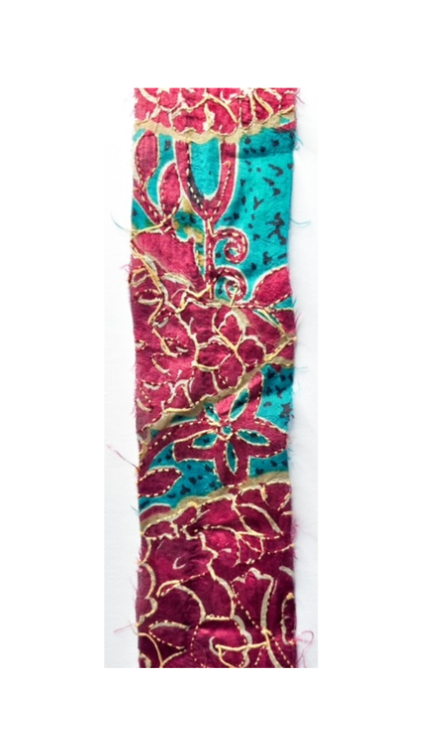 Paisley turquoise cuff bracelet with intricate red and gold floral and paisley patterns, showcasing vibrant and detailed embroidery on a textured background.