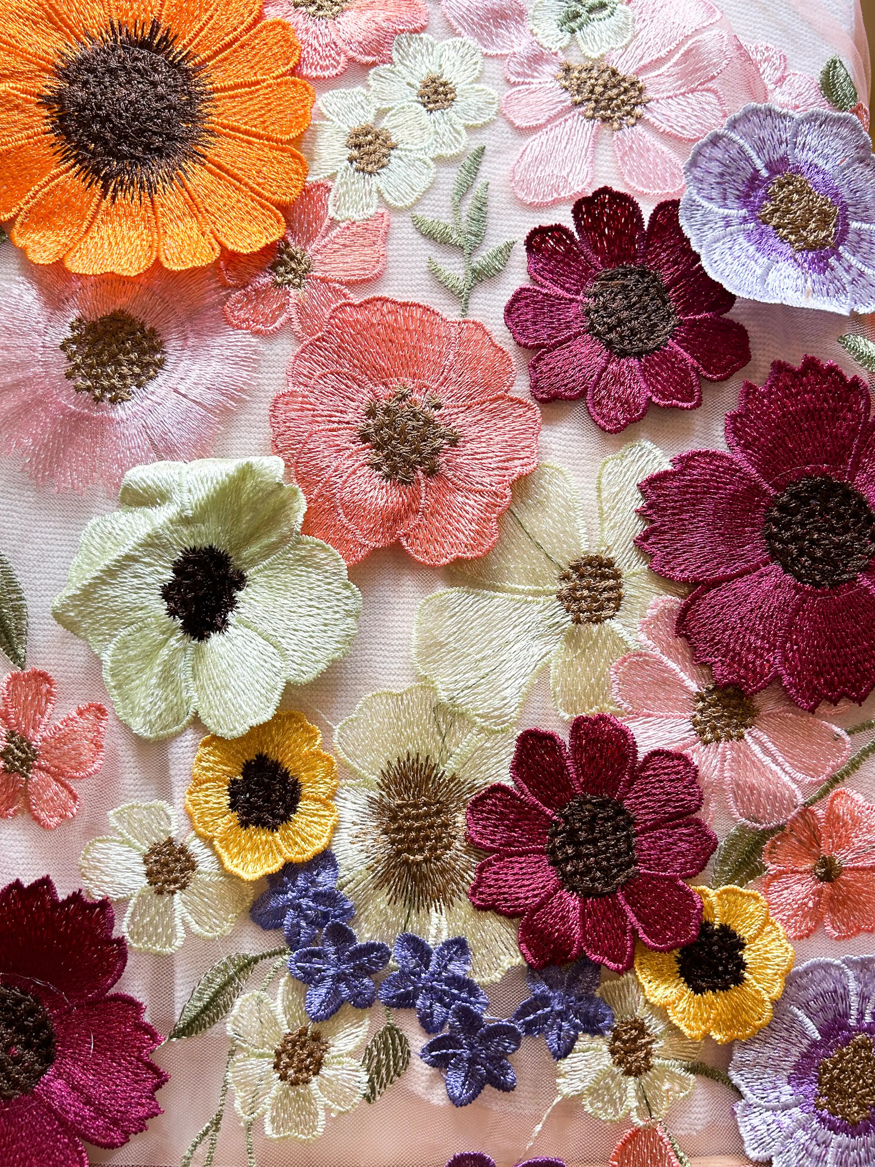 Close-up of Frenchie floral cuff bracelet fabric – embroidered flowers in orange, red, yellow, purple, cream, and blue on soft white mesh, perfect for custom handmade cuff bracelets.