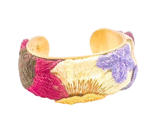 The Frenchie cuff bracelet in a 1-inch size features vibrant floral embroidery in pink, purple, and cream on a vintage brass base.