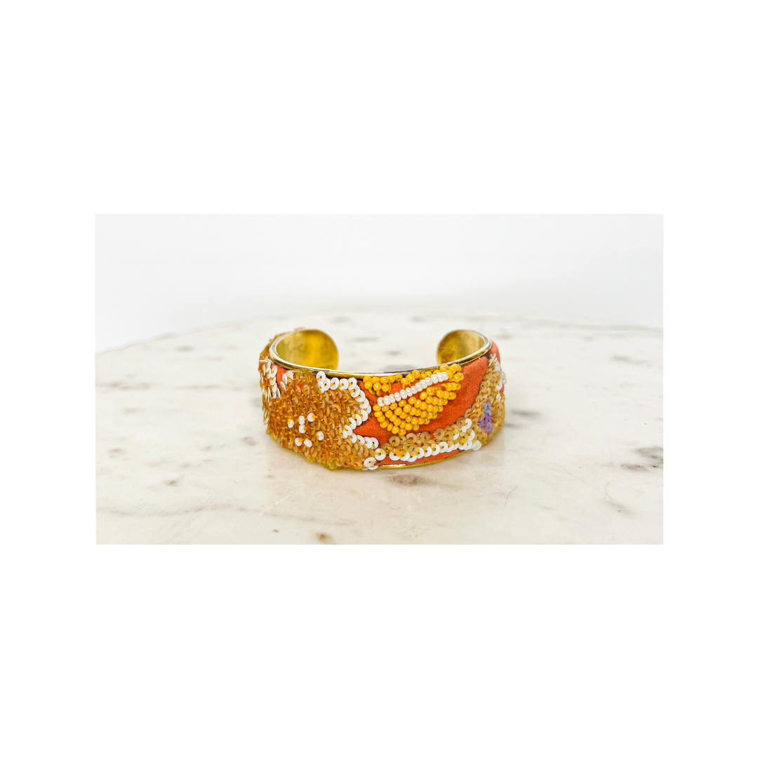Georgia beaded floral cuff bracelet – orange and gold hand-sewn floral beads and sequins on vintage fabric, 1-inch adjustable brass cuff with stamped message inside.