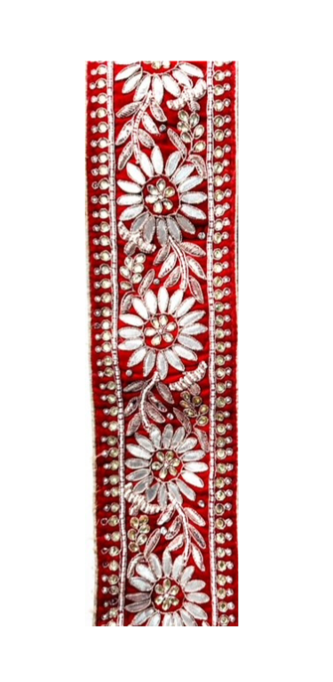 Silver and red velvet beaded cuff bracelet featuring intricate silver floral embroidery and beading on rich red velvet fabric, creating a luxurious and detailed design.