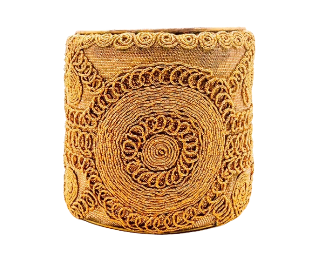 The Goldie cuff bracelet by Redd Dott Jewelry features intricate gold circular embroidery on a vintage brass base. This bold, 3-inch handcrafted piece adds texture and elegance to any outfit.