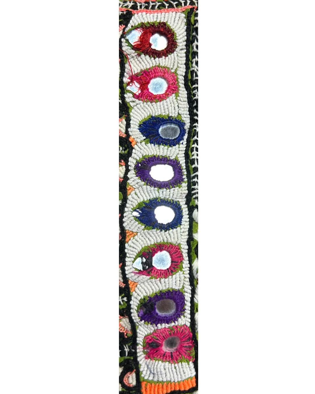 A handcrafted custom stamped cuff bracelet by Redd Dott Jewelry featuring oval mirrored accents with colorful embroidered borders on ivory fabric. A vibrant, folk-inspired piece of embroidered jewelry.