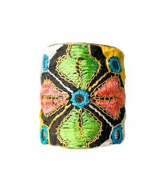 Indian-inspired jewelry piece featuring a handcrafted cuff bracelet with intricate floral patterns in colorful threads, showcasing traditional hand-stamping techniques.
