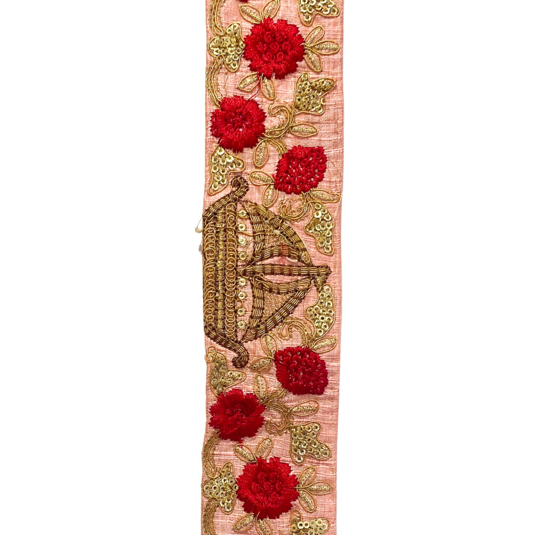 Gold cuff bracelet with a blush pink fabric base, intricate gold embroidery, sequins, and vibrant red floral accents, custom-stamped and handmade by Redd Dott Jewelry.