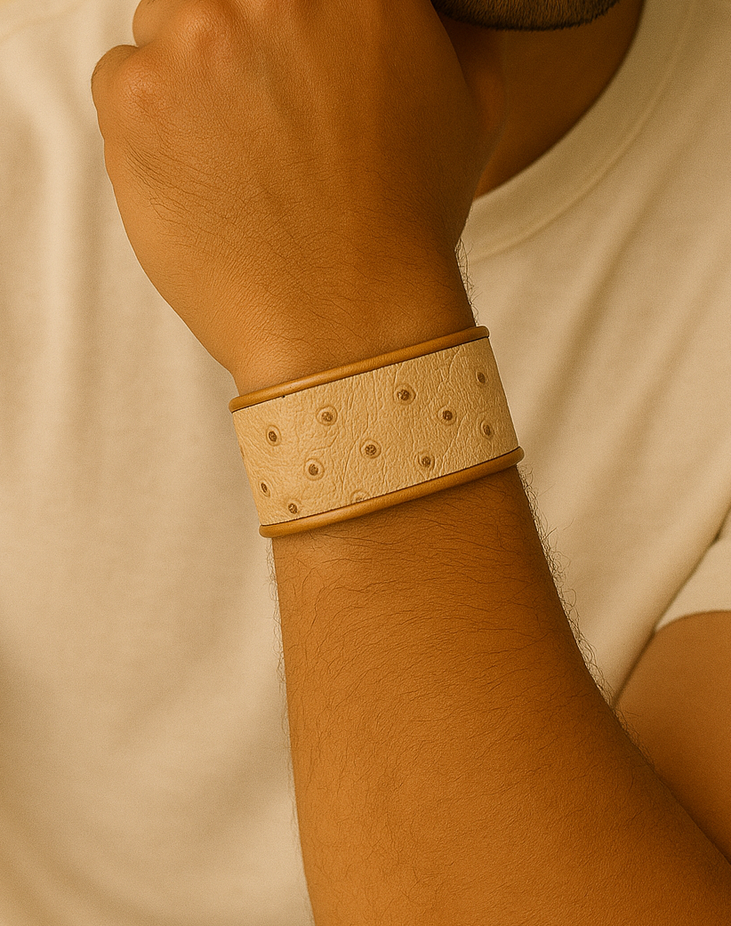 Close-up of a model wearing a men’s 1-Inch ostrich leather brass cuff bracelet by Redd Dott Jewelry, featuring natural ivory-toned leather with raised quill texture set into a slim brass cuff, highlighting the refined surface detail and handcrafted jewelry finish, handcrafted in Shreveport, LA by Redd Dott Jewelry.