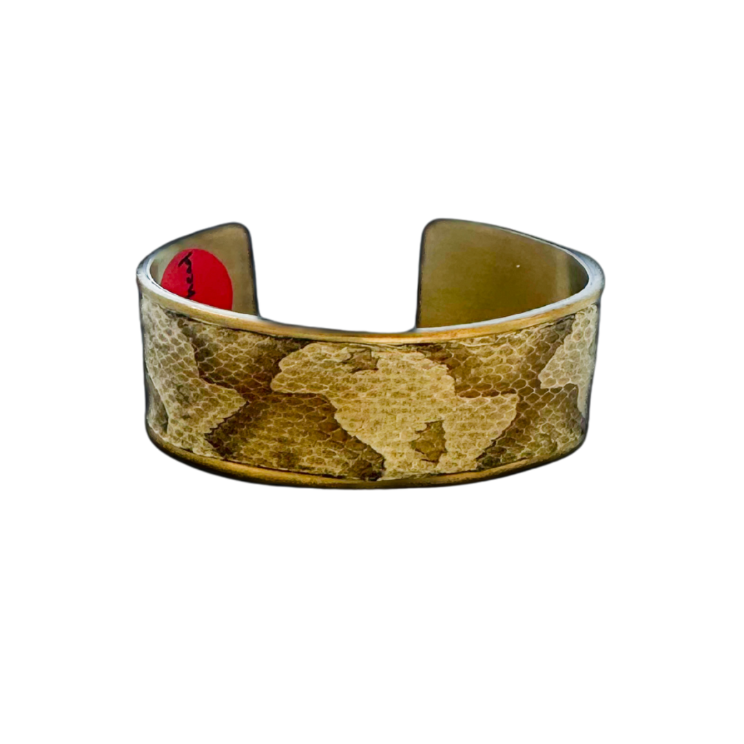 1-inch gold cuff bracelet handcrafted with genuine copperhead snake skin in soft golden and bronze tones, featuring natural geometric scale pattern and brass interior; statement jewelry by Redd Dott.