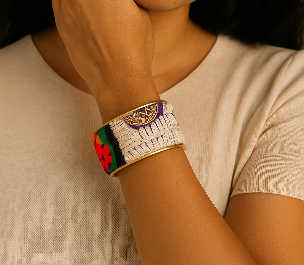 Woman wearing the Ashari Custom Stamped Brass Cuff Bracelet with cream, gold, and violet embroidery, handcrafted in Shreveport, LA by Redd Dott Jewelry.