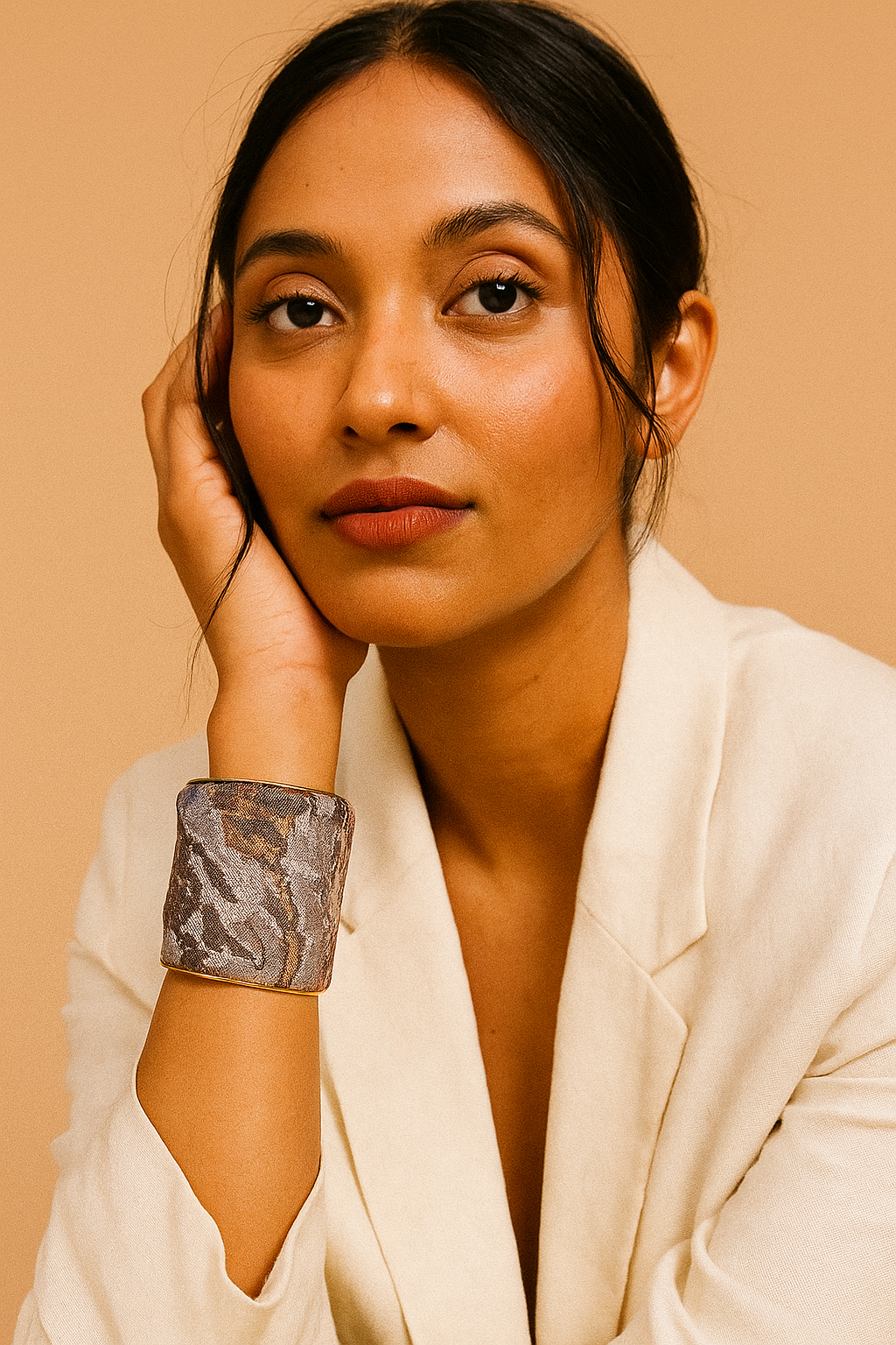 Woman wearing the Abbi inspirational brass cuff bracelet in neutral tones of grey, black, and gold, swirling in an abstract; distressed design handcrafted in Shreveport, LA by Redd Dott Jewelry.