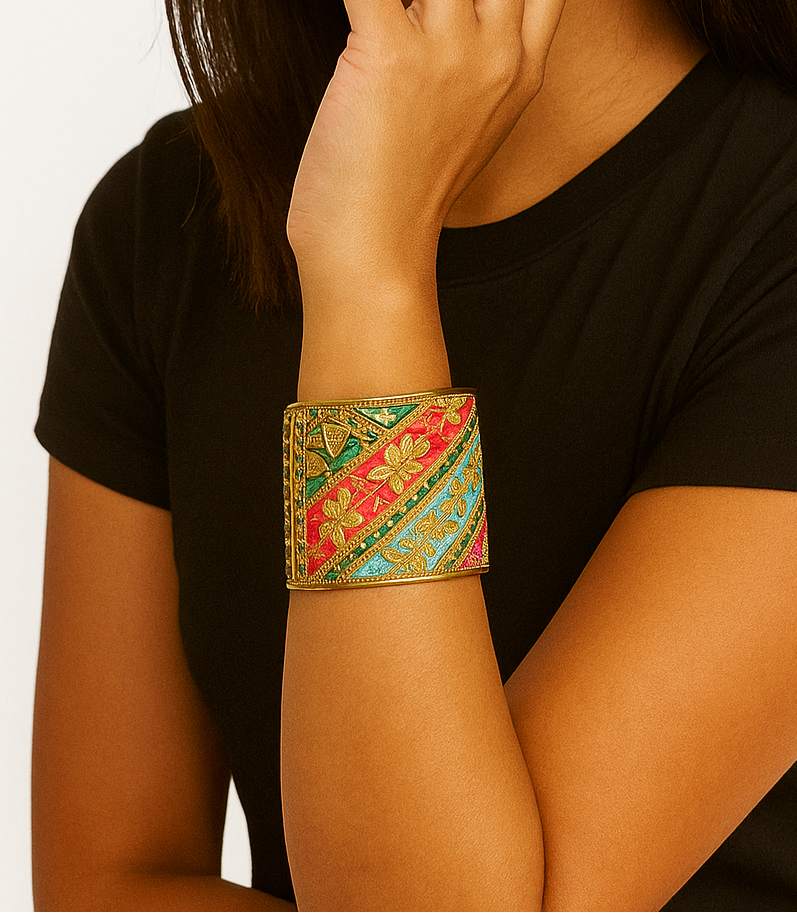 Woman wearing the Alexia Custom Quote Bracelet, a floral embroidered brass cuff with floral embroidered fabric with gold, green, red, and turquoise threads and gold detailing, handcrafted in Shreveport, LA by Redd Dott Jewelry.