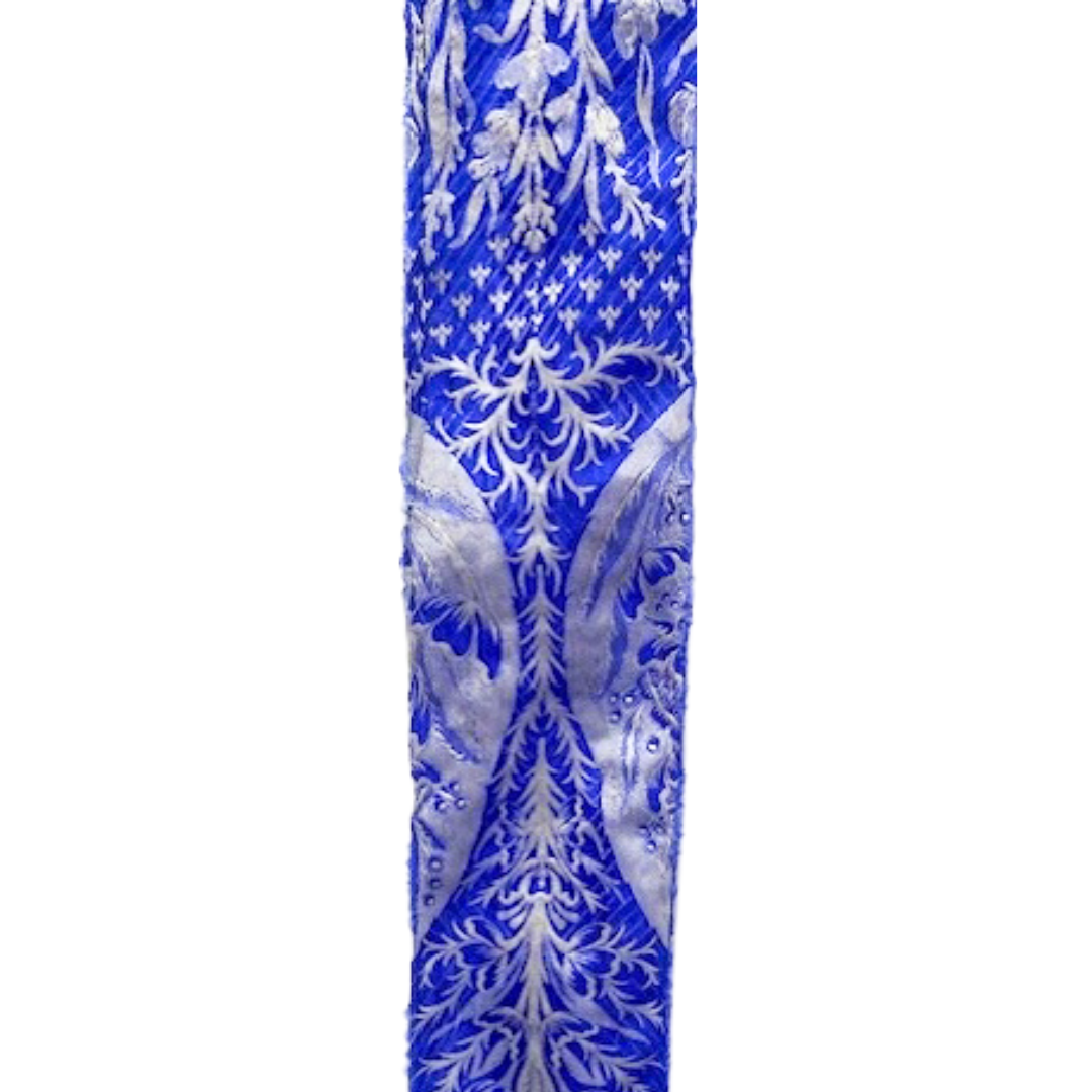 Statement cuff bracelet with a vivid royal blue fabric base and intricate silver floral-inspired patterns, custom-stamped and handmade by Redd Dott Jewelry.