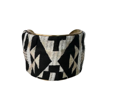 Vintage-inspired cuff bracelet with geometric black and gold metallic patterns, showcasing an elegant combination of modern shapes and classic metallic textures.
