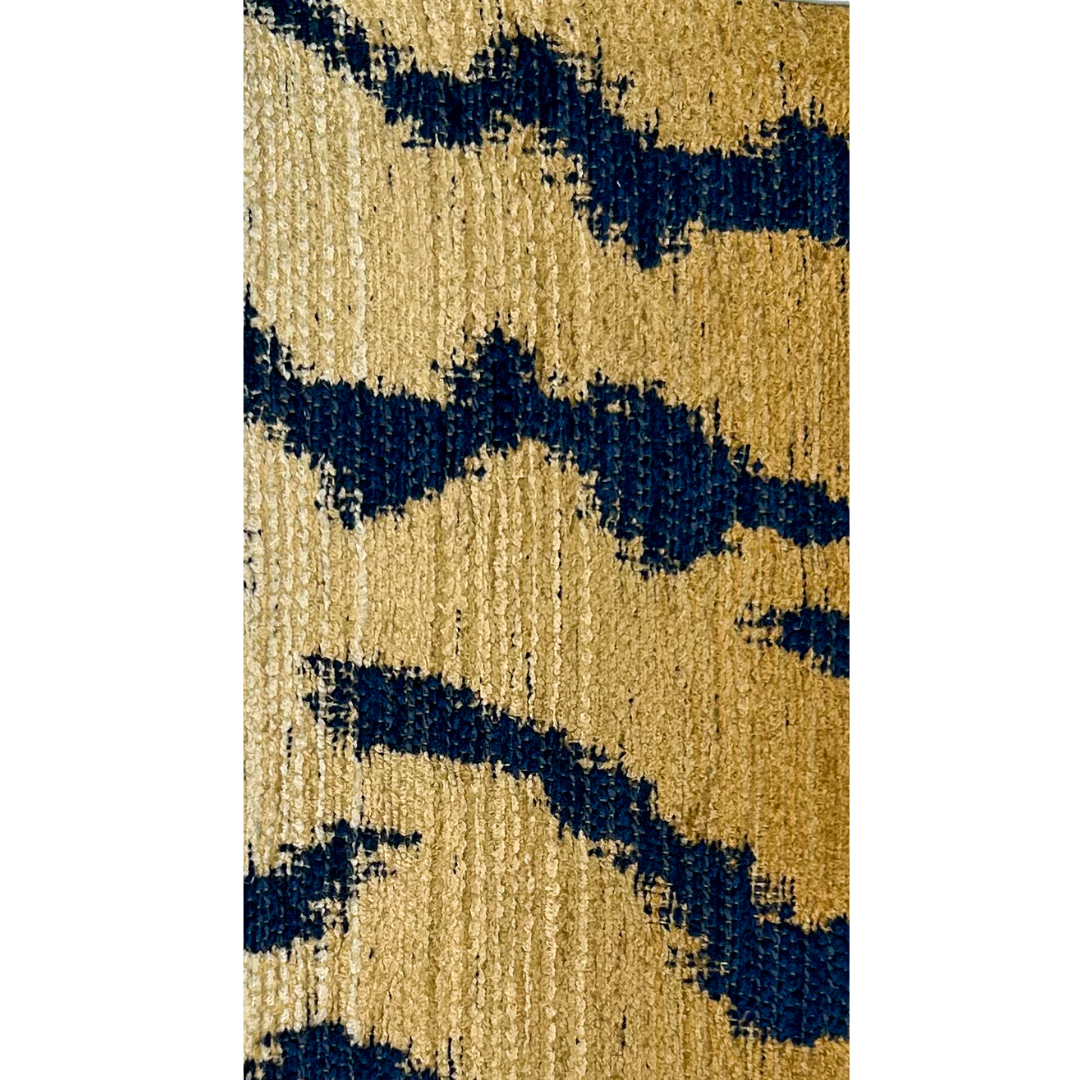 A nature-inspired jewelry piece by Redd Dott Jewelry, featuring a bold navy and gold abstract pattern on textured fabric.