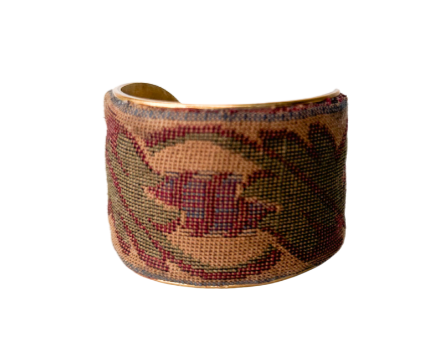 Handcrafted vintage-inspired embroidered cuff bracelet featuring intricate floral patterns in earthy tones, offering a timeless and elegant accessory.