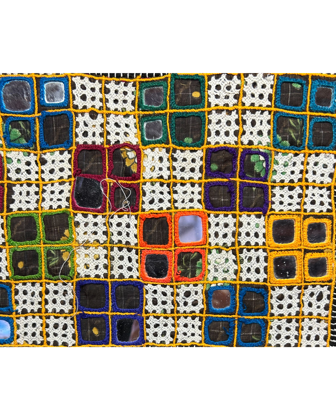 A handcrafted custom stamped cuff bracelet by Redd Dott Jewelry featuring embroidered multicolor squares, mirrored accents, and lace inserts. A bold, textural vintage brass bracelet and unique piece of embroidered jewelry.