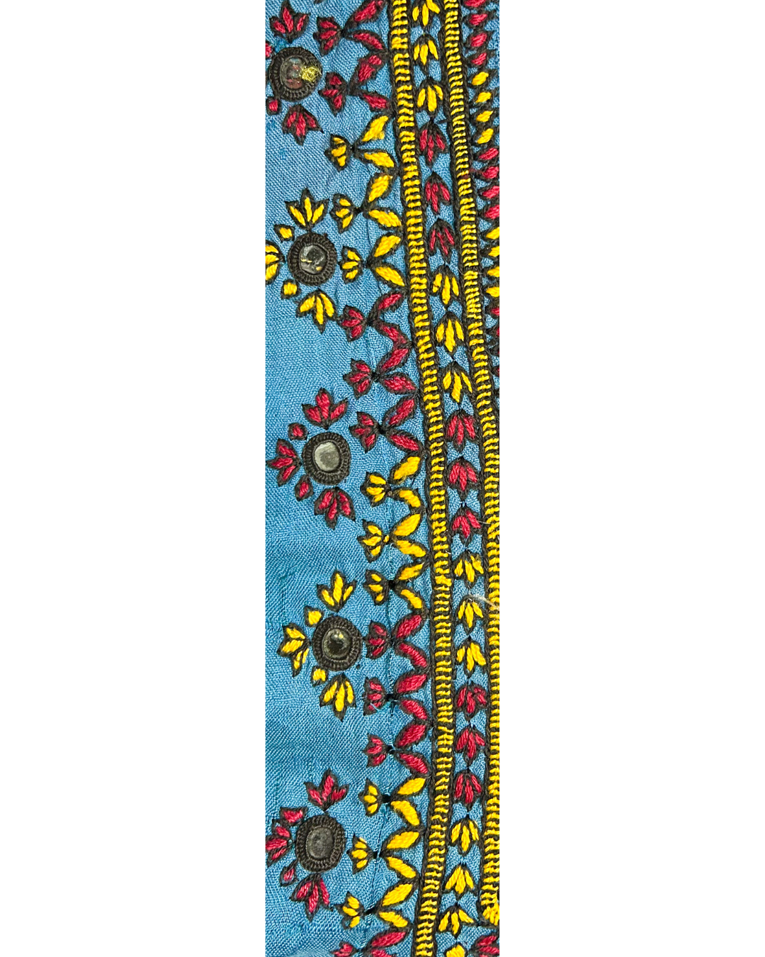 A handcrafted custom stamped cuff bracelet by Redd Dott Jewelry with small mirrored florals and dense yellow and red embroidery on sky-blue vintage fabric. A radiant vintage brass bracelet and expressive work of embroidered jewelry.