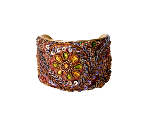 Gold cuff bracelet for women with detailed hand-stamped and embroidered patterns in rich hues, showcasing artisanal craftsmanship in a bold and elegant design.