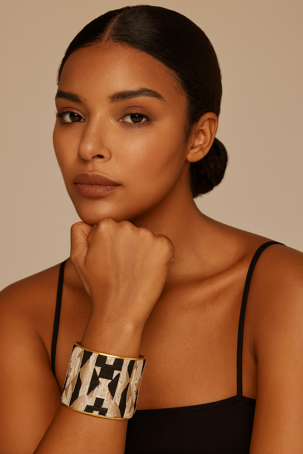 Model wearing the Redd Dott Nala 2-inch cuff bracelet, featuring a bold black and gold geometric pattern framed in gold, blending modern edge with timeless sophistication.