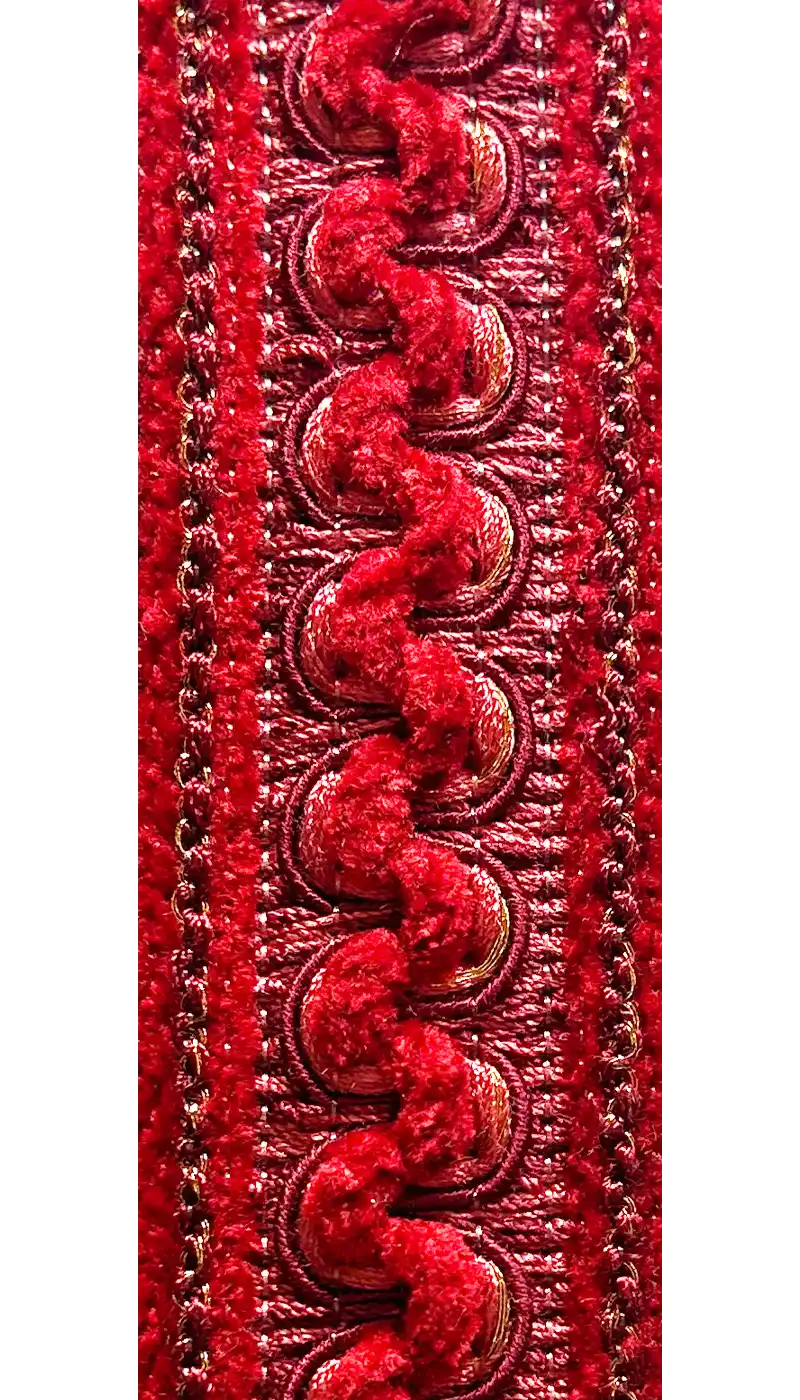 Close-up view of a Customizable Red Inspirational Jewelry Cuff Bracelet showcasing an ornate velvet and braided pattern in rich red hues.