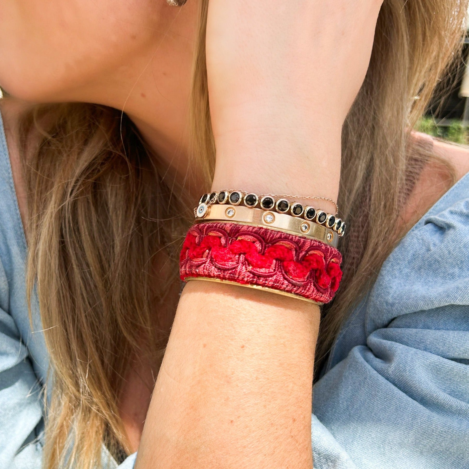 Handcrafted velvet cuff bracelet with a red swirl design, adding a bold and luxurious touch to any outfit.
