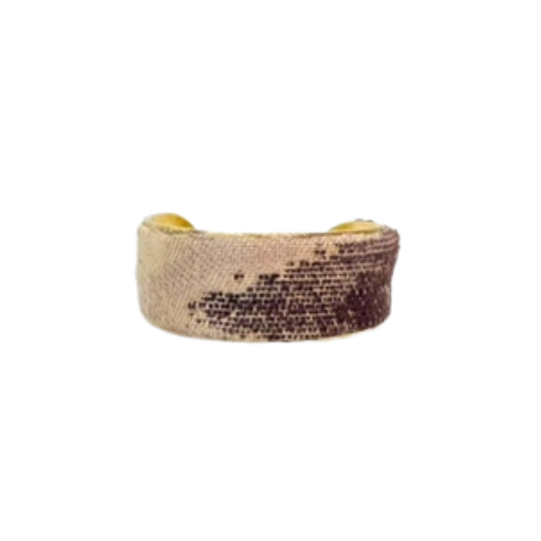 Wisteria cuff bracelet – 1-inch brass cuff with tan fabric base and soft purple overlaid pattern, handmade and minimalist.