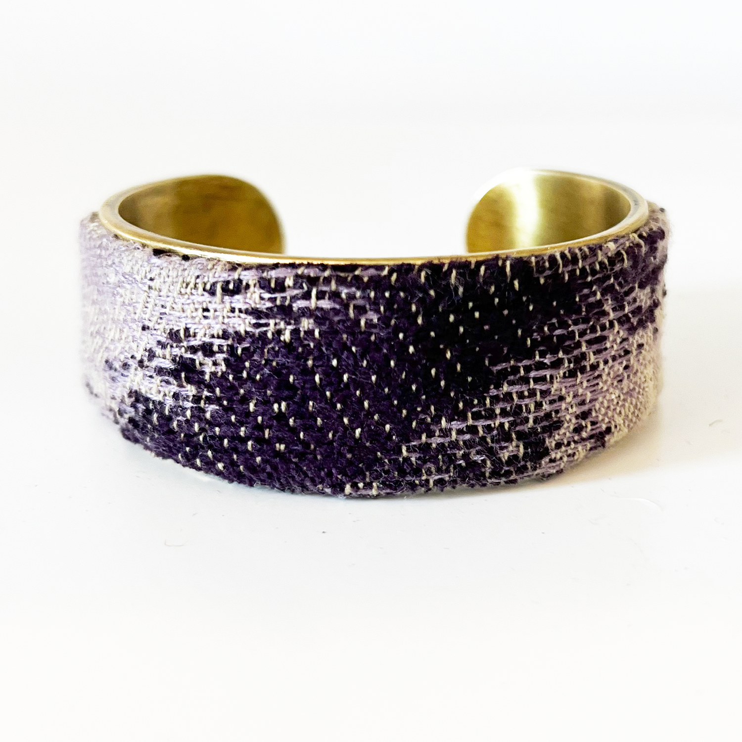 Wisteria cuff bracelet – deep plum and lavender woven over a textured tan base on a 1-inch brass cuff, artisan-crafted.