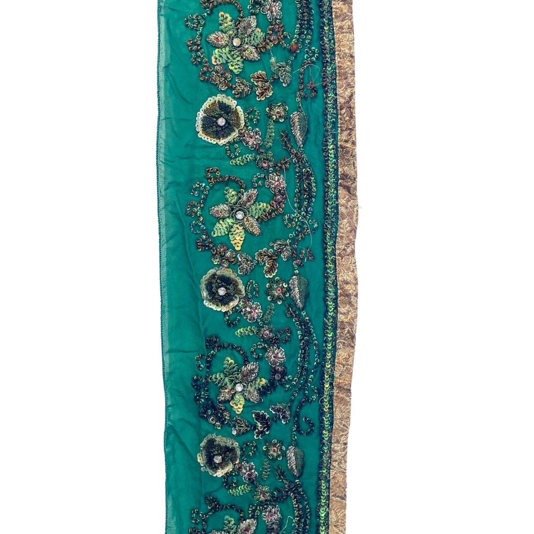 A Beaded Flower Bracelet fabric by Redd Dott Jewelry, featuring an emerald green base with intricate floral beadwork, shimmering sequins, and crystals. The gold-accented edges and detailed embroidery add elegance, making this fabric a beautiful and eye-catching piece