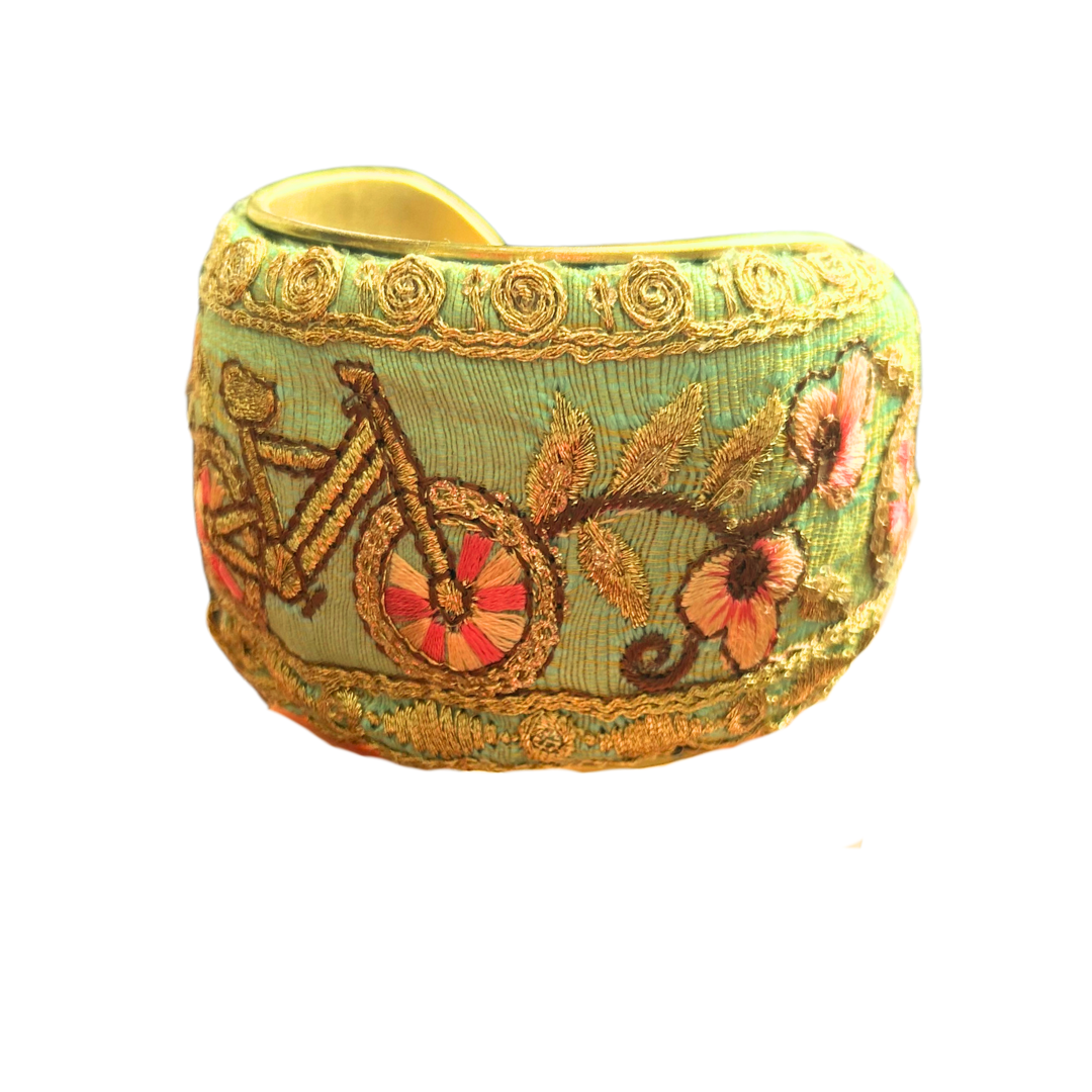 Ambrose floral cuff bracelet – embroidered bicycle on mint green fabric with coral blossoms and gold scroll trim, handcrafted by Redd Dott Jewelry.