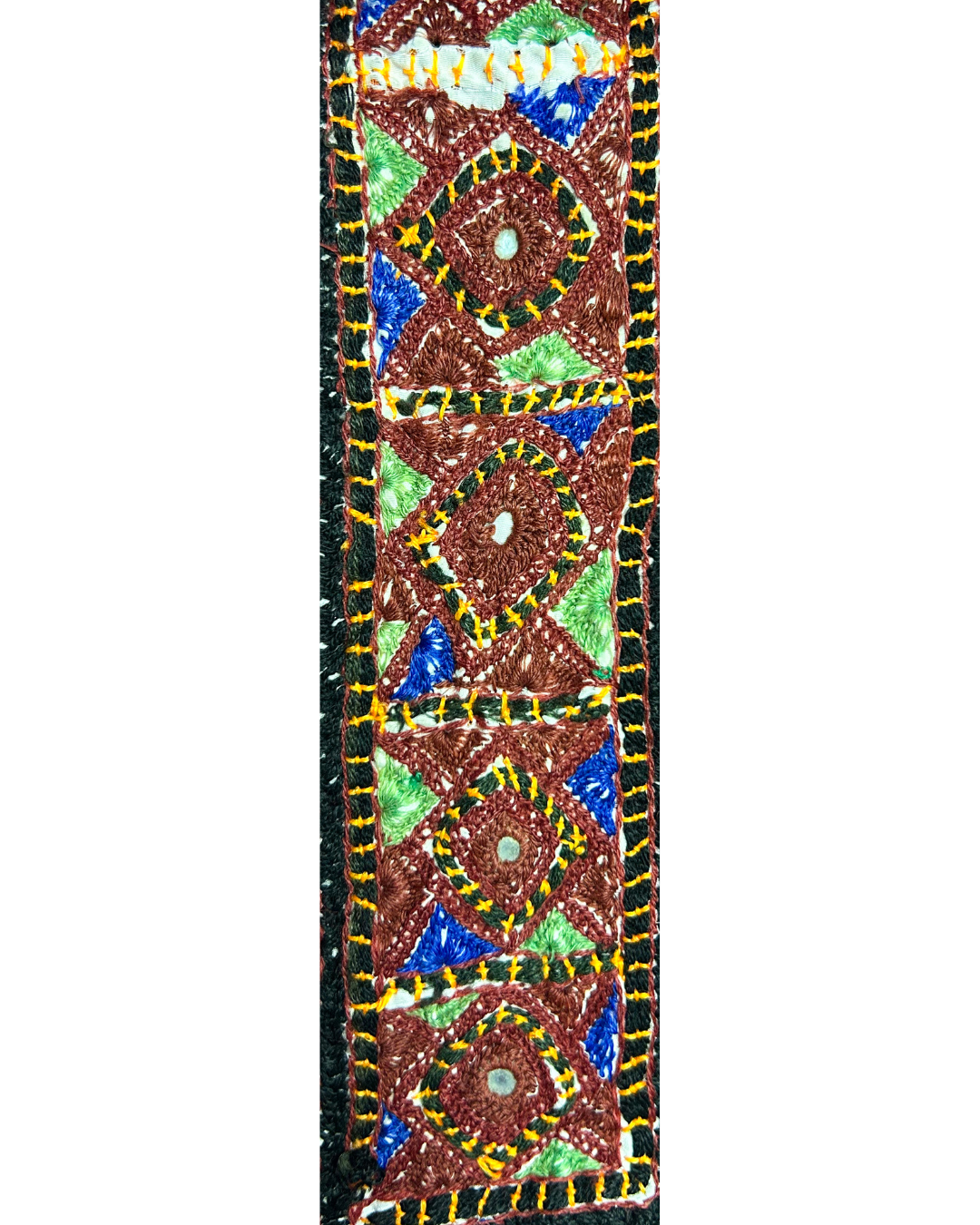 A handcrafted custom stamped cuff bracelet by Redd Dott Jewelry featuring brown, green, and blue geometric embroidery with mirror accents. A textured rustic cuff bracelet and bold piece of embroidered jewelry.