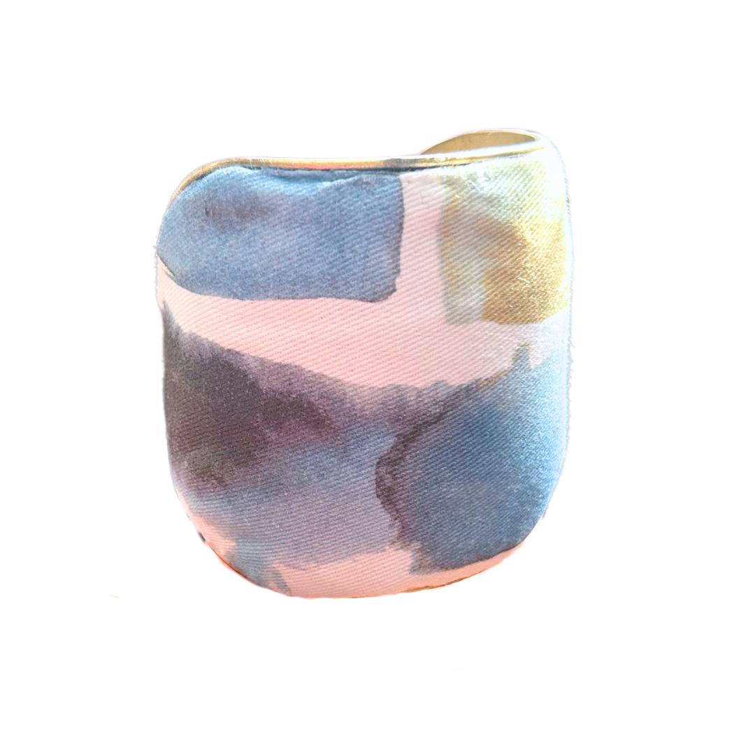 Bode custom stamped cuff bracelet – abstract watercolor print with blue, gold, and black brushstrokes on ivory fabric, handcrafted on a brass base by Redd Dott Jewelry.