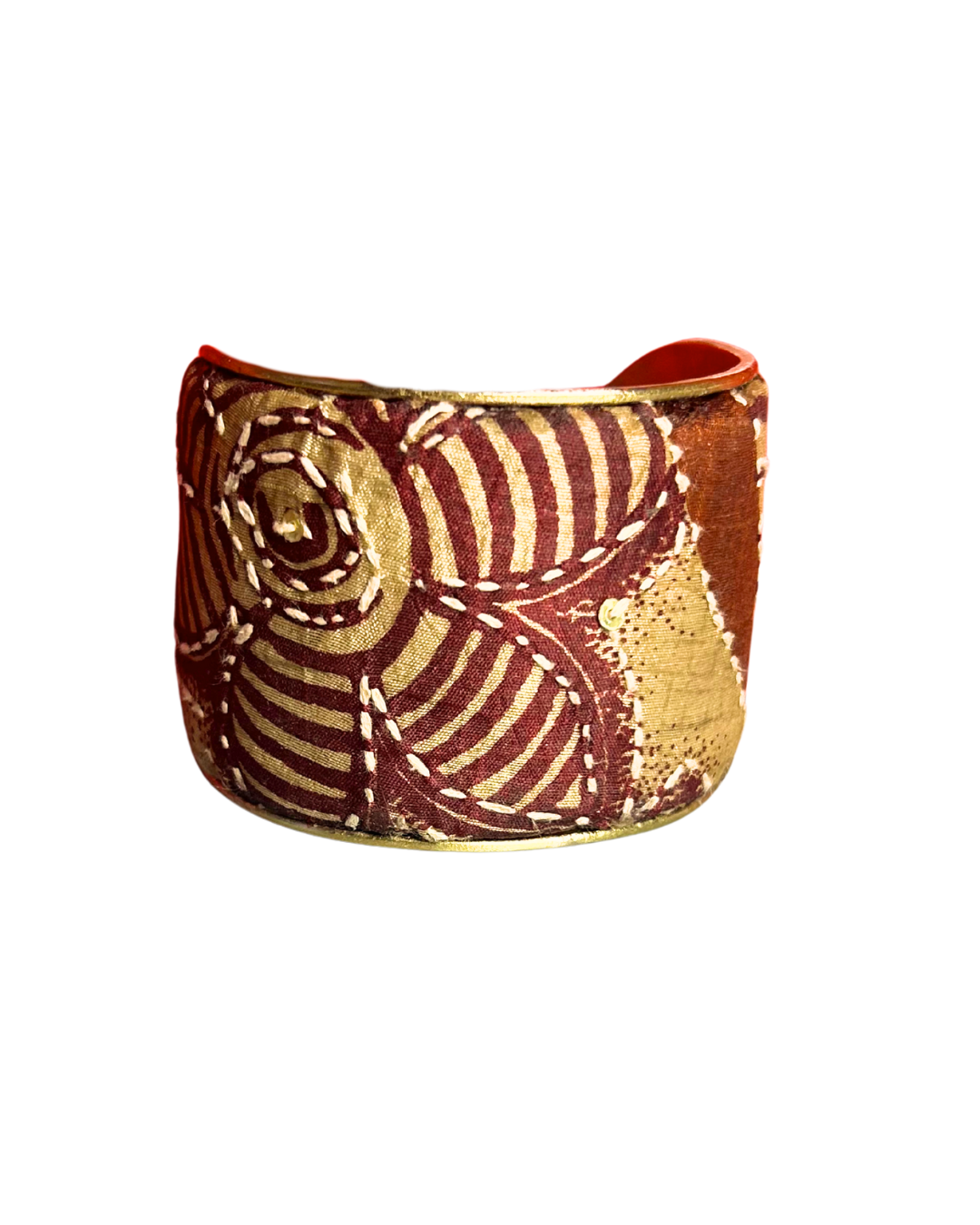 A handmade rustic cuff bracelet from Redd Dott Jewelry, crafted and stamped in Shreveport, LA. Features earthy rust-toned fabric embroidered with concentric natural patterns—an elegant piece of embroidered jewelry and nature inspired jewelry.