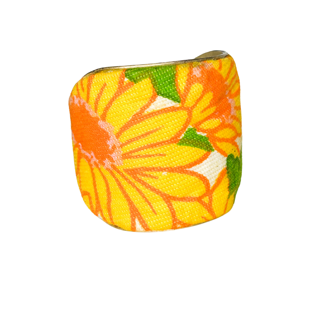 Helen 3-inch retro floral cuff – oversized yellow blossoms with orange and green detailing on vintage fabric wrapped around a wide brass cuff.